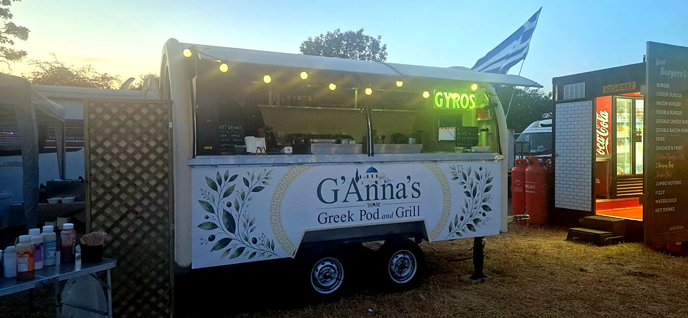 The GYROS sign glowing at sunset